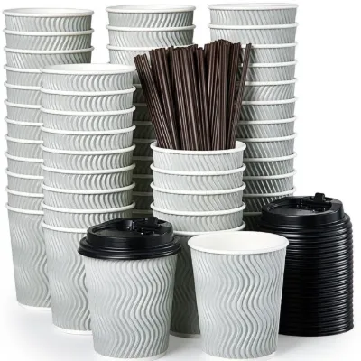 Stacks of grey ripple-wall paper cups with black lids and brown stirrers